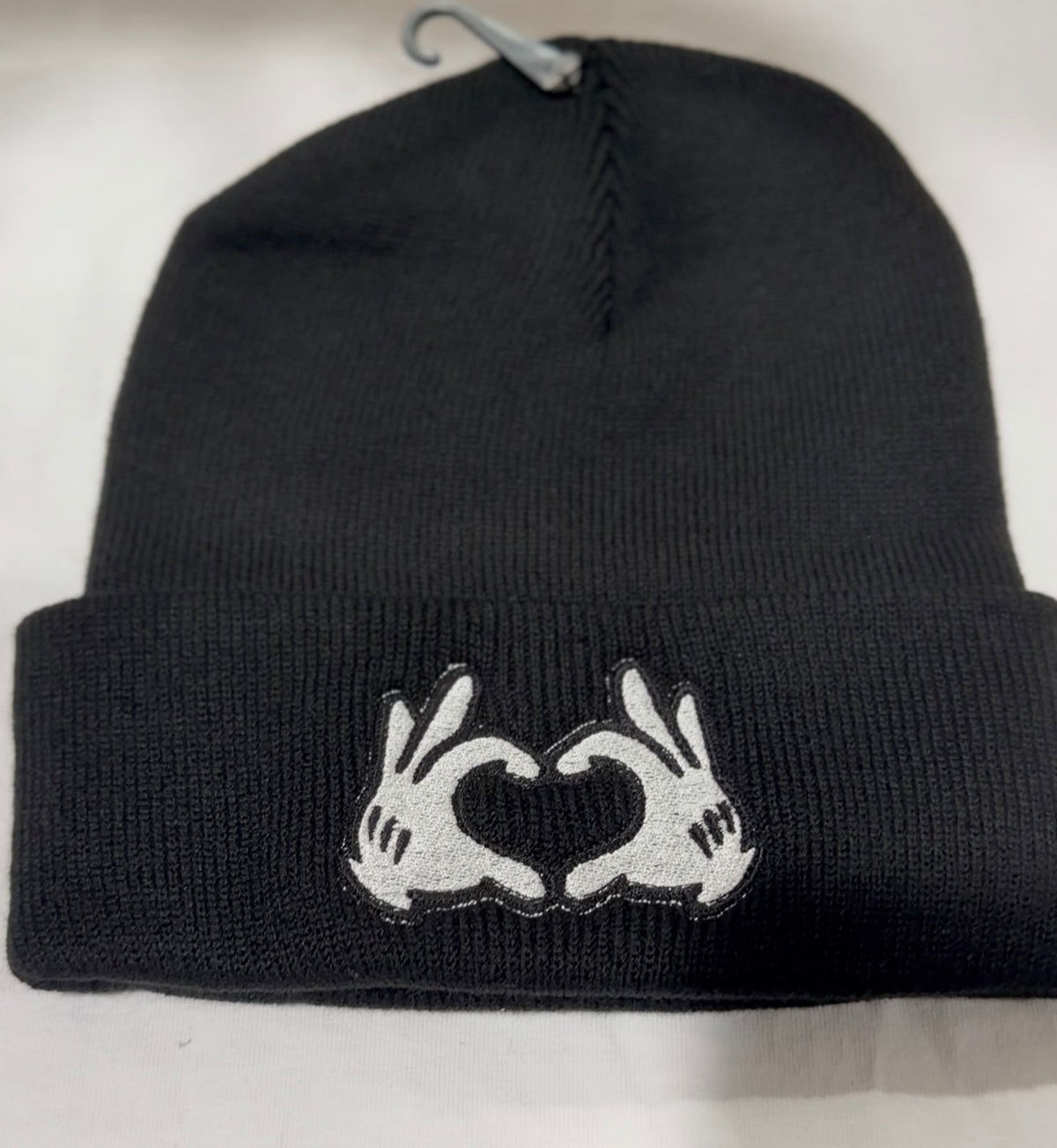 black beanie with heart hands embroidered design